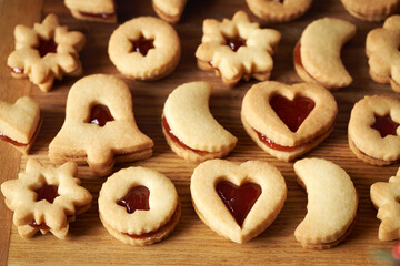 Homemade Linzer Christmas cookies filled with strawberry marmalade