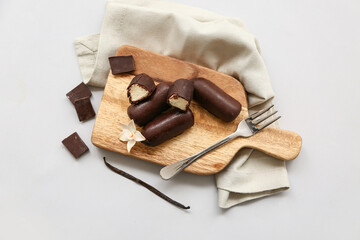 Board with curd bars and vanilla on grey background