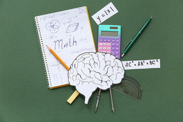 Paper brains with notebook and school stationery on chalkboard