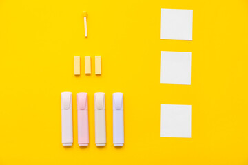 Paper sheets and school stationery on yellow background