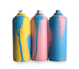 Different spray paint cans on white background
