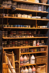 Cozy Pottery Studio with Ceramic Supplies and Mugs on Shelves