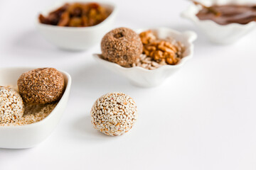Healthy handmade sweets, balls, candies made from natural ingredients. Energy dessert made from nuts, cacao, seeds, coconut, berry. Sugar free. Vegetarian organic food. White background