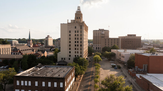 Monroe, Louisiana, USA - April 4, 2024: Afternoon sunlight shines on the historic buildings in the skyline of downtown Monroe.