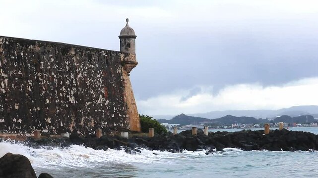 waves crashing against rocks in front of Castillo San Felipe del Morro in Old San Juan puerto rico caribbean island sea travel (beautiful spanish fort) footage coast ocean bastion guerite promenade