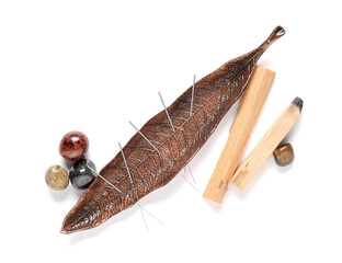 Acupuncture needles, palo santo and stones on white background