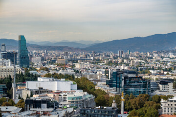 View from the hill of mother Georgia on the city center of Tbilisi, Georgia with mountains in the...