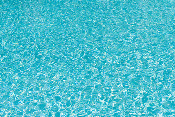 Vacation resort water background. Sea beach. Summer vacation at ocean shore. Blue ocean rippled water texture reflection. Ripple water in summer pool. Sea surface background. Relaxation time