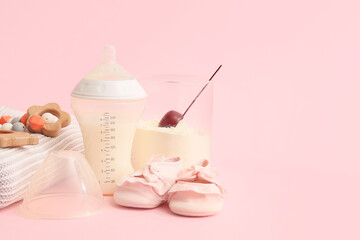 Bottle with baby milk formula, booties, plaid and toys on color background