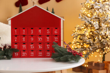 Advent calendar with Christmas branches on table in living room, closeup