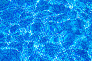 Top view blue ripped water in swimming pool with texture and refraction