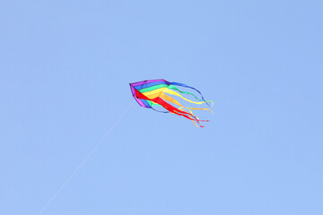 bright colourful kite against a blue sky
