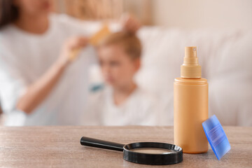 Remedy for pediculosis with head lice comb and magnifier on table in room, closeup