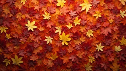 Vibrant autumn maple leaves in red orange and yellow hues creating a textured seasonal backdrop