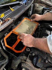 mechanic changing car engine