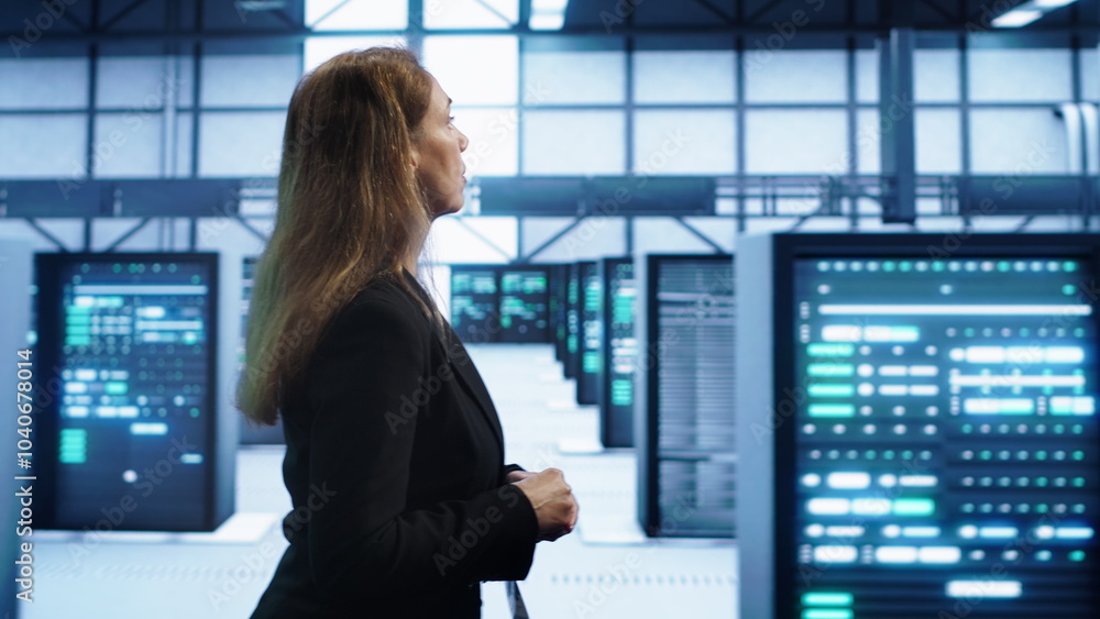 Poster engineer inspecting server room hardware, walking between supercomputers. it professional supervisin