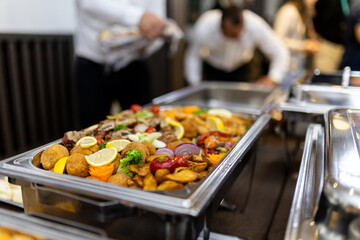 Delicious buffet spread with various dishes and colorful garnishes at a gathering during an evening event