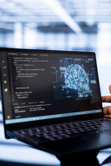 Computer scientist using laptop in data center, updating AI systems. Close up shot of device used...