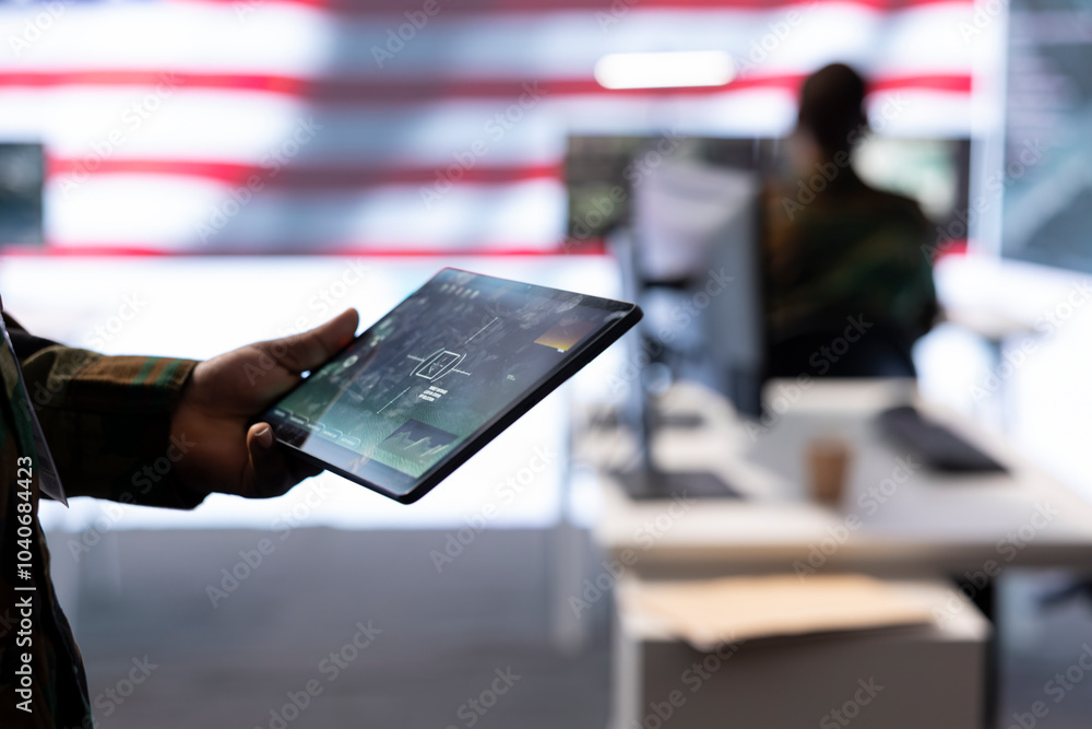 Poster team of military experts operates high tech computers and tablet to analyze surveillance data and ma