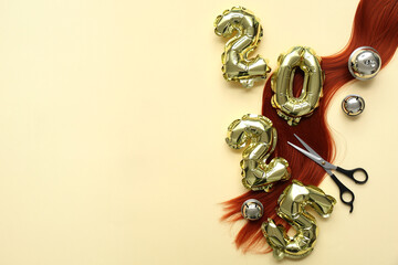 Figure 2025 with hair strand, scissors and Christmas bells on yellow background