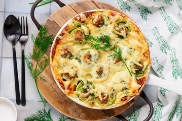 Baked zucchini rolls with minced meat, egg and cheese..selective focus