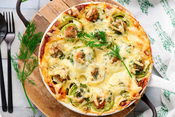 Baked zucchini rolls with minced meat, egg and cheese..selective focus