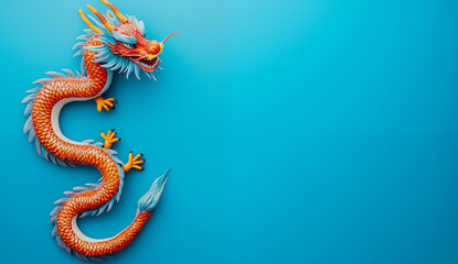Fototapeta premium colorful chinese dragon on a blue background with copy space, top view - festive new year