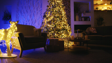 Beautifully decorated living room with a christmas tree and presents illuminated by warm fairy lights, creating a cozy and festive atmosphere