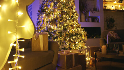 Transforming a cozy living room into a warm and inviting space with christmas lights. Presents neatly arranged beneath a decorated tree
