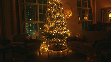 Brightly lit christmas tree illuminating a cozy living room with presents on the armchairs, while the city lights are shining through the windows