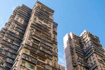 Towering high-rise and aged residential apartment buildings are densely packed with numerous...