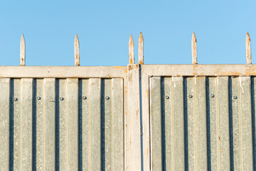 top edge of a metal gate with metallic spikes, safety concept background