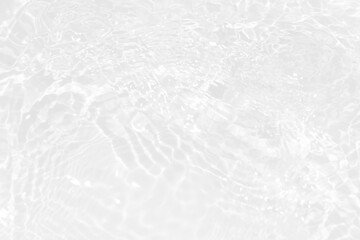 White water with ripples on the surface. Defocus blurred transparent white colored clear calm water surface texture with splashes and bubbles. Water waves with shining pattern texture background.