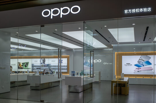 The storefront of an OPPO electronics store in Ningbo China, where various devices are displayed on shelves and counters for customers to choose and buy