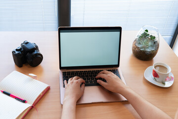 Hands of photographer working on laptop