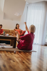 A joyful family scene featuring playful interactions in a cozy living room. Captures genuine emotions and lively expressions as family members enjoy quality time together.