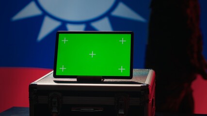 Taiwan army commander devising strategy to combat Chinese propaganda next to green screen tablet. Taiwanese freedom fighter walking in operation room in front of mockup device, camera A