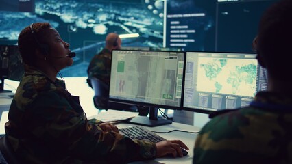 Woman army officer operates on gps surveillance footage to gather crucial information about enemy plans. Operator examines a satellite world map to provide support to field troops. Camera B.