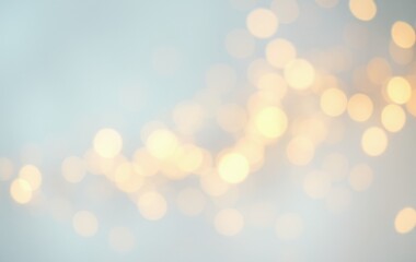 Golden light particles on a light blue backdrop