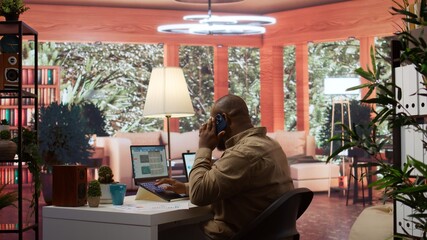 Entrepreneur reviewing statistics data on a laptop remotely from his house, makes a briefing report. Business owner studying sales numbers and the profit to increase organizational funds. Camera B.
