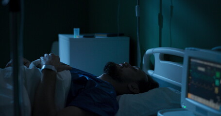 Patient playing games on phone in hospital bed .