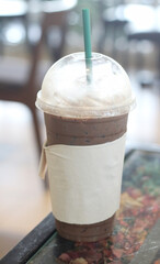 cup of iced cocoa with a straw