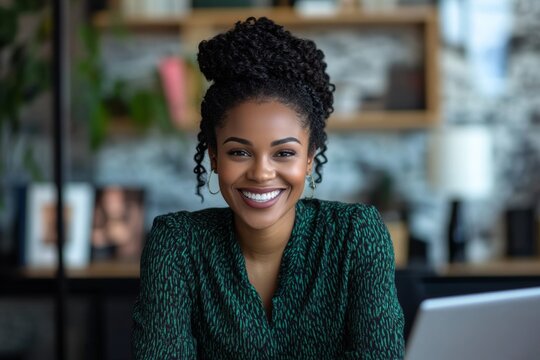 Happy African American woman participating in a remote team meeting while working from home in a modern office setting