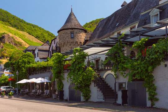A historic house with a stone tower and terrace covered in vines in Beilstein, Germany