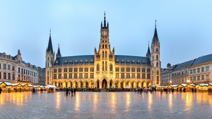 Illuminated Bruges Medieval Town Hall and Clock Tower in Historic Market Square at Night