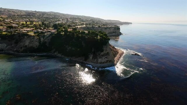 Stunning Drone Footage of Aerial Descent towards Penisula of Lunada Bay over Calm Ocean and Kelp Gardens in Palos Verdes, California