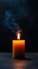 Burning candle with smoke against a dark background, creating a serene atmosphere.