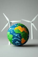 Fototapeta premium Colorful globe with wind turbines on a neutral backdrop, symbolizing sustainability.