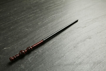 One old magic wand on black table