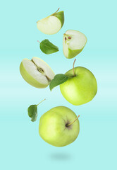 Fresh green apples in air on turquoise background